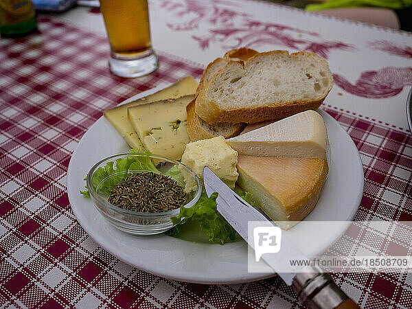 Close-up of French cheese and baguette meal on table  Vosges  France