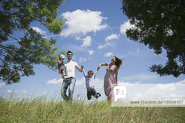 Happy family enjoying on meadow in the countryside  Bavaria  Germany