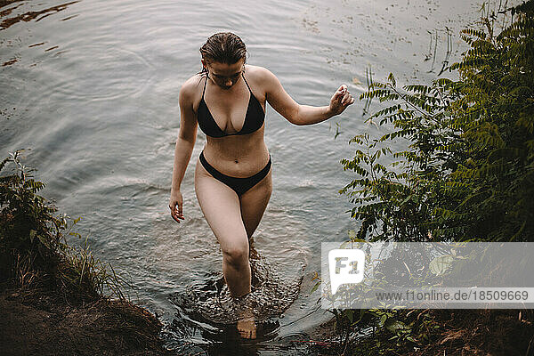 Sensual woman coming out from lake