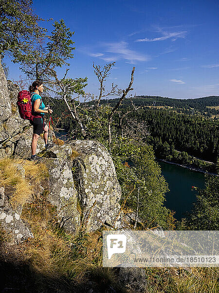 Rear view of women hiker looking at view of forest from mountains at Lac Blanc  Vosges  France
