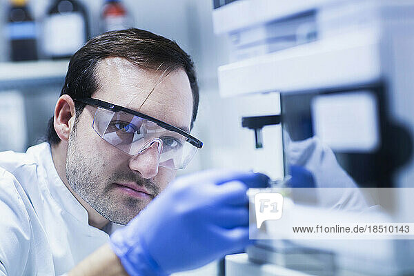Young male scientist examining in a laboratory  Freiburg Im Breisgau  Baden-wuerttemberg  Germany