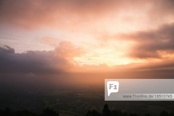 Bright sunlight through clouds at sunrise over the malvern