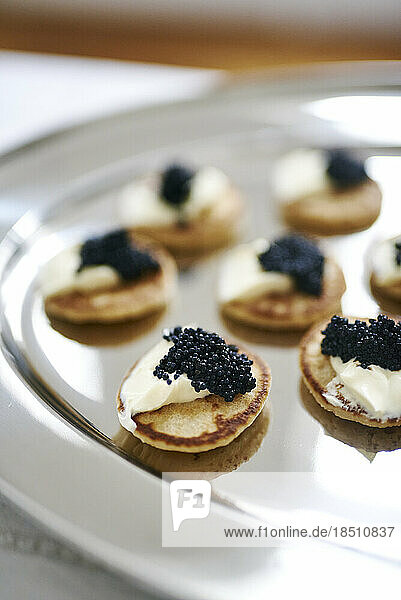 Delicious looking caviar and cream cheese platter on silver tray