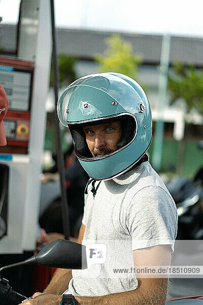 A man in a motorcycle helmet. Bali  Indonesia