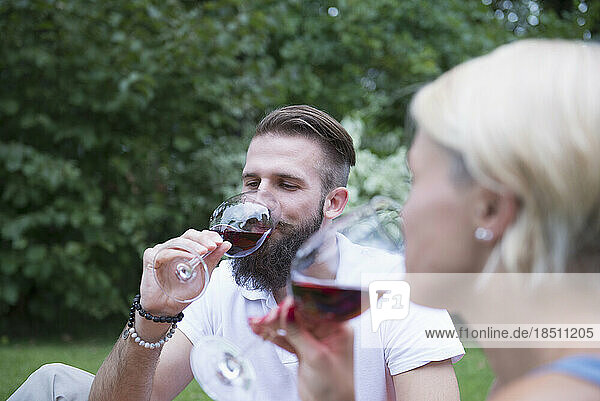 Young couple enjoying red wine at picnic  Bavaria  Germany