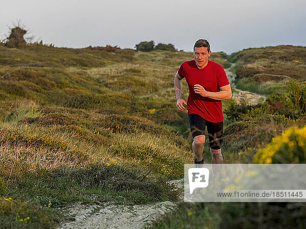 Man trail running no cliff of Getxo