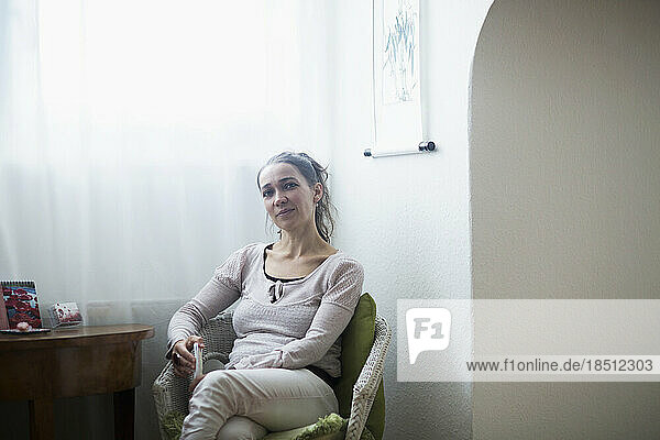 Portrait of a female healer sitting on chair  Freiburg im Breisgau  Baden-Württemberg  Germany