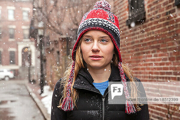 Girl in Knit Hat Standing in the Snow