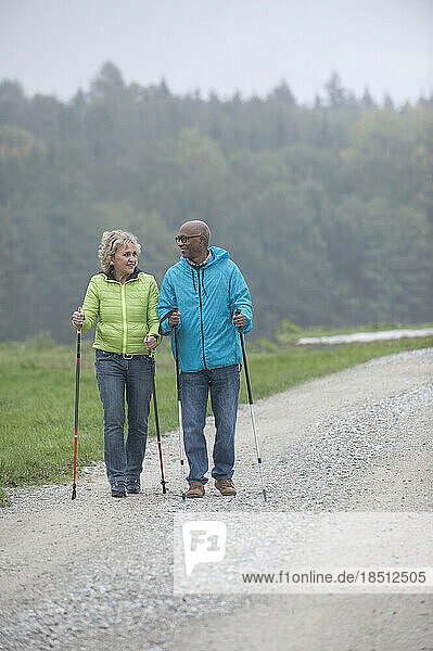 Senior couple hiking with hiking poles  Bavaria  Germany