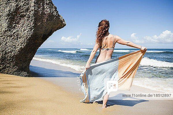 Solo Woman in a bikini with towel at the beach in Puerto Rico