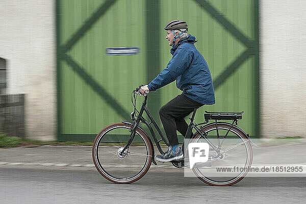 Mature man with cycling helmet on his bicycle  Bavaria  Germany