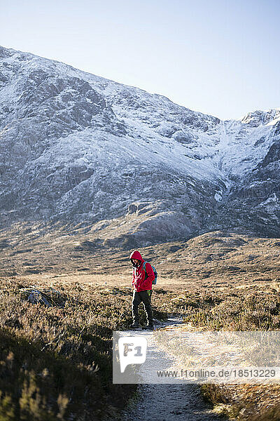 Solo Man hiking in Scottish Highlands in winter