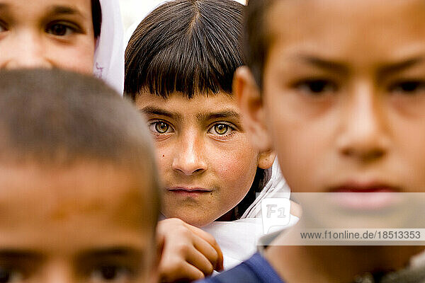Children's faces as they wait for school to start in Kabul.