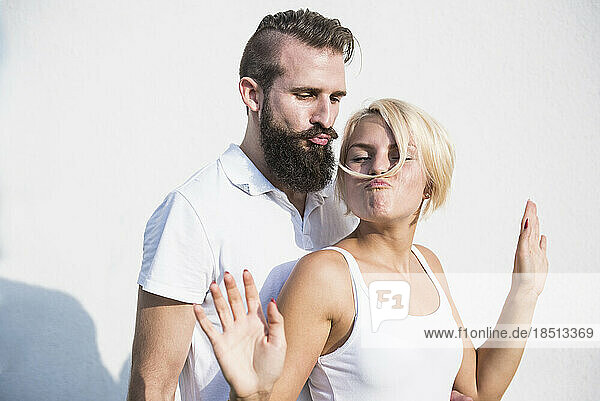 Young man with his playful girlfriend making moustache with hair  Bavaria  Germany