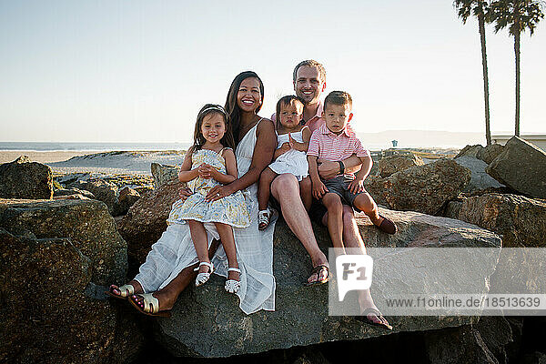 Family of Five Posing on Rocks at Coronado Beach in San Diego