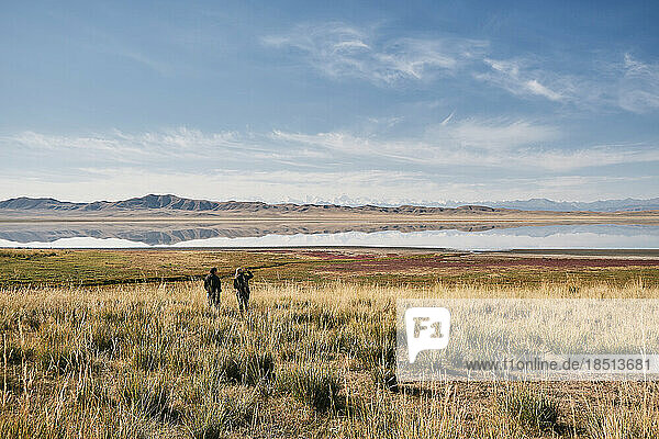 Couple travelers walks through the area near the lake TuzKol