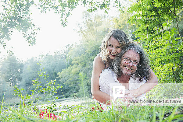 Portrait of happy couple hugging around in nature  Bavaria  Germany
