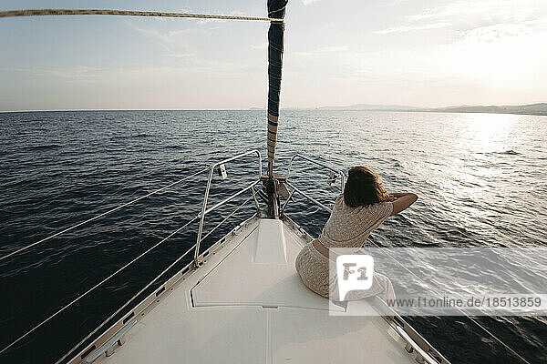 Woman leaning on railing of sailboat