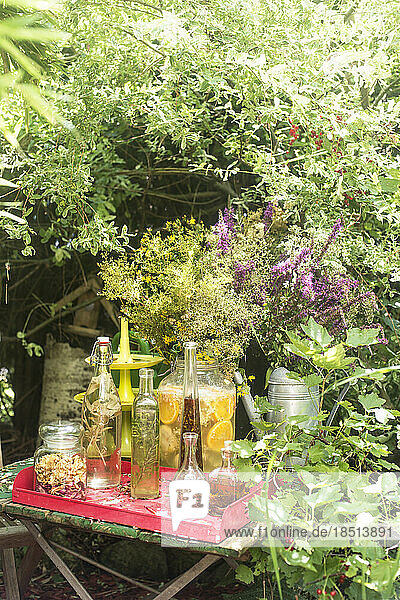 Fresh oils and vinegar in glass bottles on tray at table