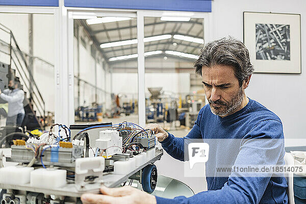 Engineer examining machine in industry