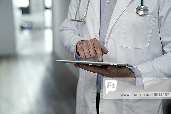 Doctor using tablet PC in clinic