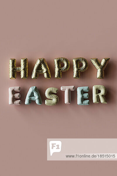 Three dimensional render of inflatable letters spelling phrase Happy Easter