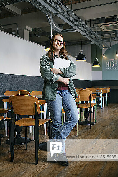 Young freelancer leaning on table at cafe