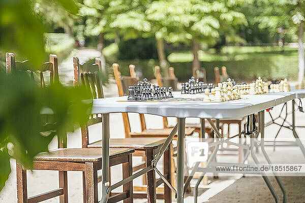 Spain  Madrid  Empty chairs in front of outdoor chess tables in El Retiro Park