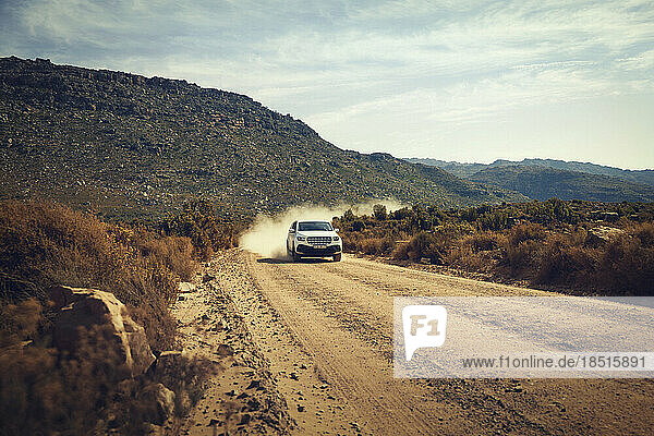 4X4 vehicle moving on dirt road amidst Cederberg Mountains