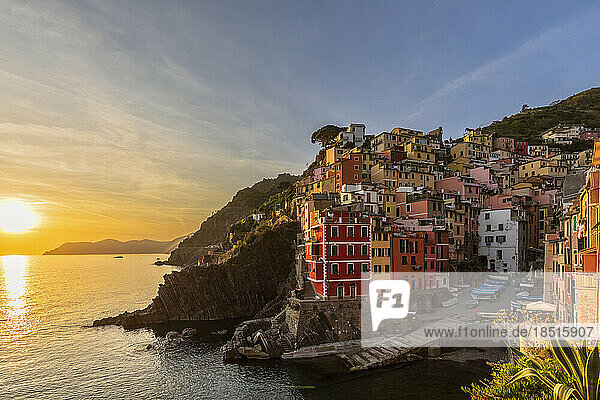 Italy  Liguria  Riomaggiore  Edge of coastal village along Cinque Terre at sunset