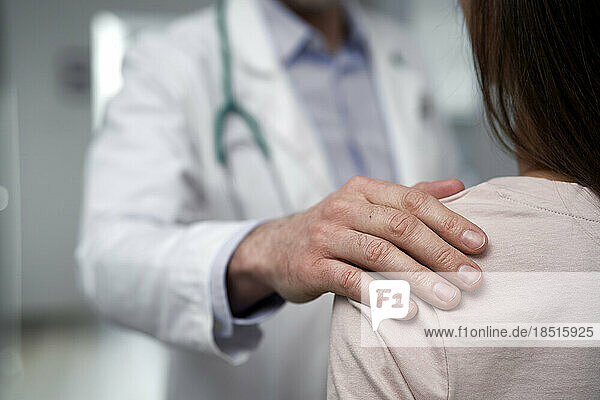 Doctor consoling patient at clinic