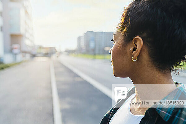 Thoughtful young woman on road