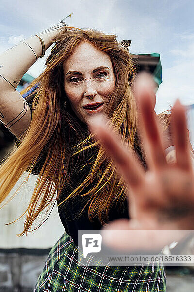 Redhead woman showing stop gesture