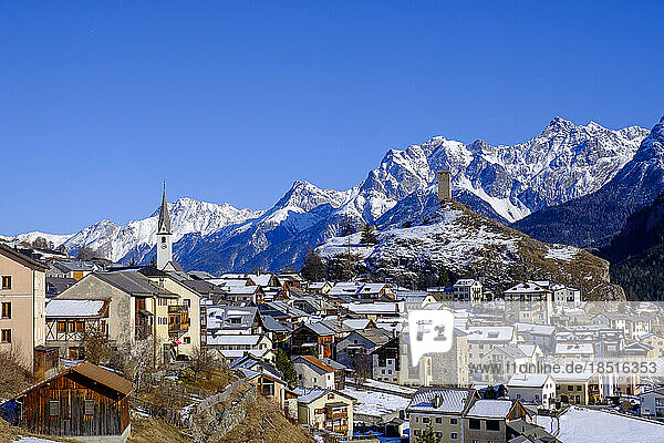 Switzerland  Graubunden Canton  Ardez  View of winter town in Engadine valley with mountains in background