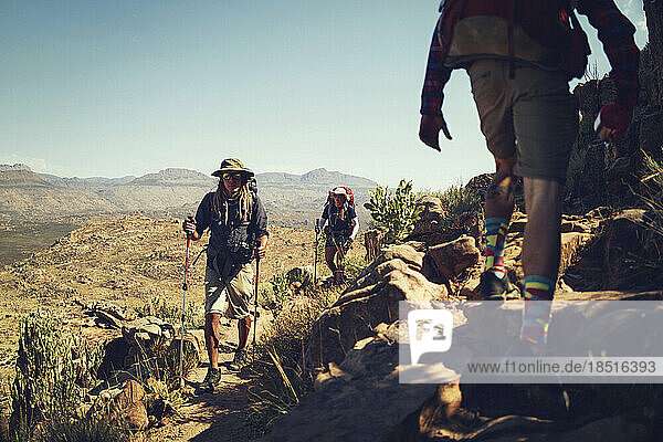 Friends with hiking poles climbing Cederberg Mountains