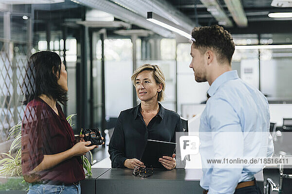 Businesswoman having discussion with colleagues in office
