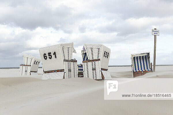 Germany  Schleswig-Holstein  St. Peter-Ording  Hooded beach chairs on sandy beach