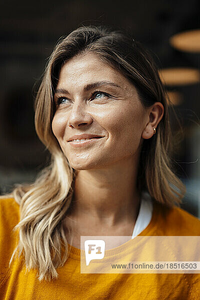 Thoughtful smiling woman with blond hair