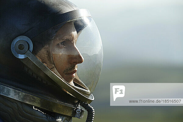 Thoughtful astronaut wearing space helmet