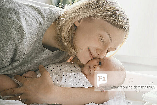 Mother embracing baby boy at home