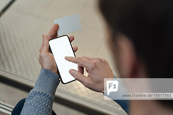 Businessman touching screen of smart phone at office