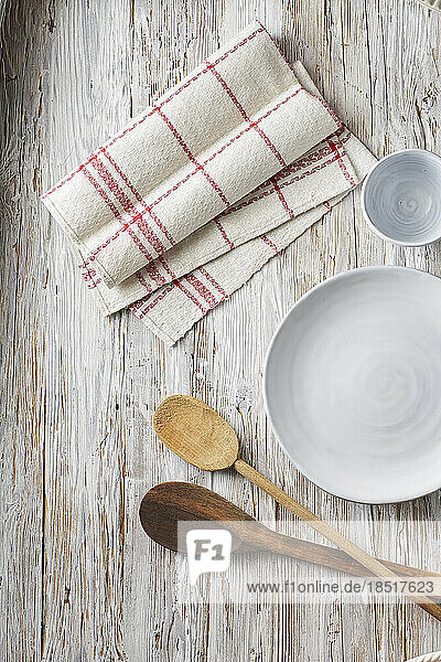Empty bowl  cup  dish towel and wooden spoons