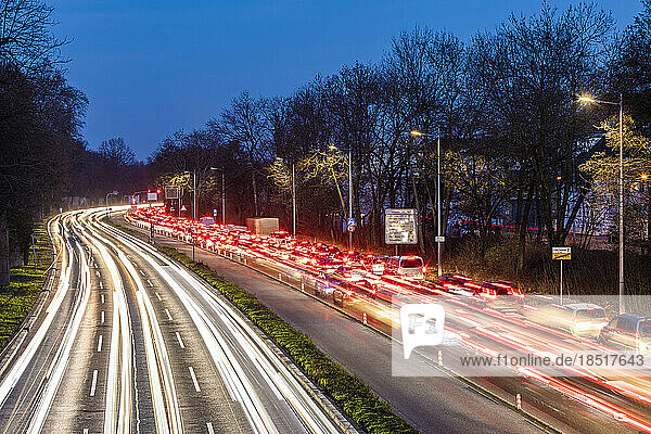 Germany  Baden-Wurttemberg  Stuttgart  Long exposure of traffic jam on multiple lane highway at dusk