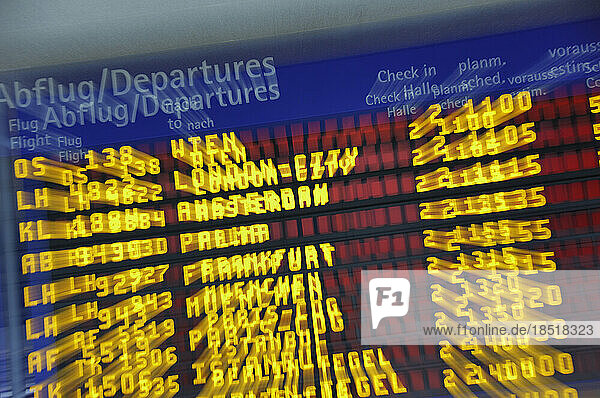 Multiple exposure of departure board in airport