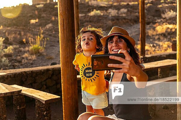 Portrait of mother and son on vacation at Tacoron beach on El Hierro  Canary Islands. taking a selfie