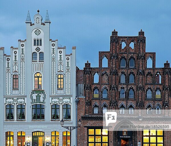 Architectural contrast: Neo-Gothic historicist gable with Jungendstil painting and the city's oldest burgher house in brick Gothic called Alter Schwede  Hanseatic City of Wismar  Mecklenburg-Western Pomerania  Germany  Europe