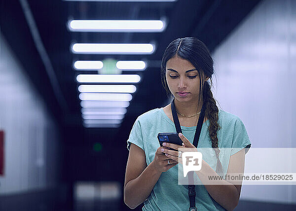 Female technician looking at smart phone