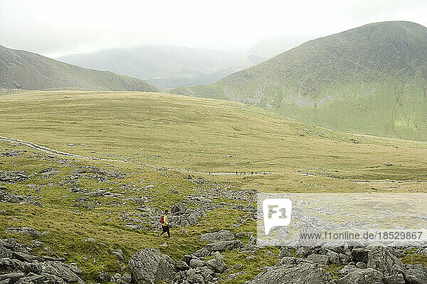 A man hiking on Mount Snowdon in Wales  England; Mount Snowdon  Wales  England