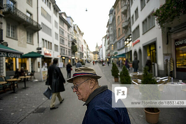 Senior man strolls through a city market in Zurich  Switzerland; Zurich  Switzerland