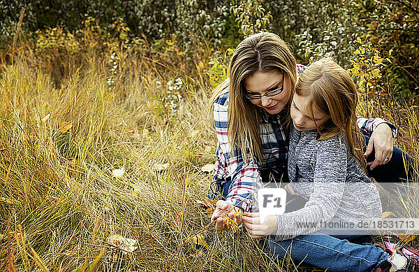 Outdoor portrait of a mother spending time with her daughter in a park area in autumn; Edmonton  Alberta  Canada